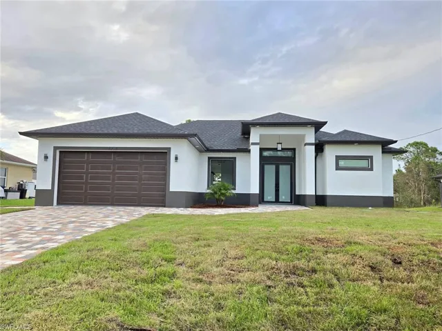Prairie-style home with a front lawn and a garage