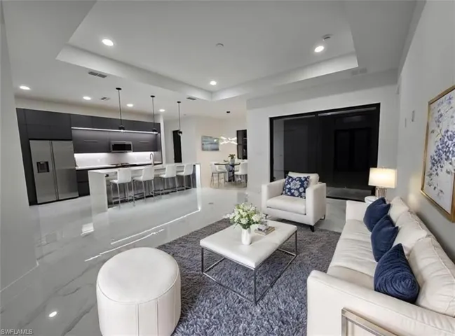 Living room featuring a raised ceiling-Virtually Staged
