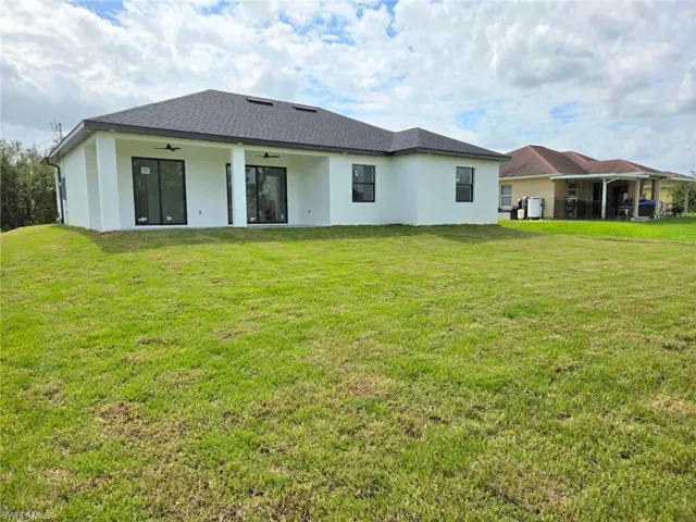 Back of house featuring a lawn