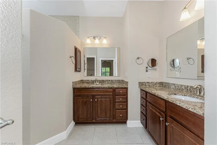 Bathroom with tile patterned flooring and vanity