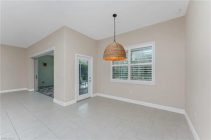 Spare room featuring light tile patterned floors and a healthy amount of sunlight