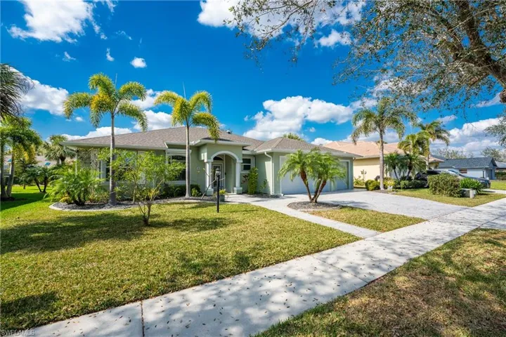 Ranch-style home featuring a garage and a front yard