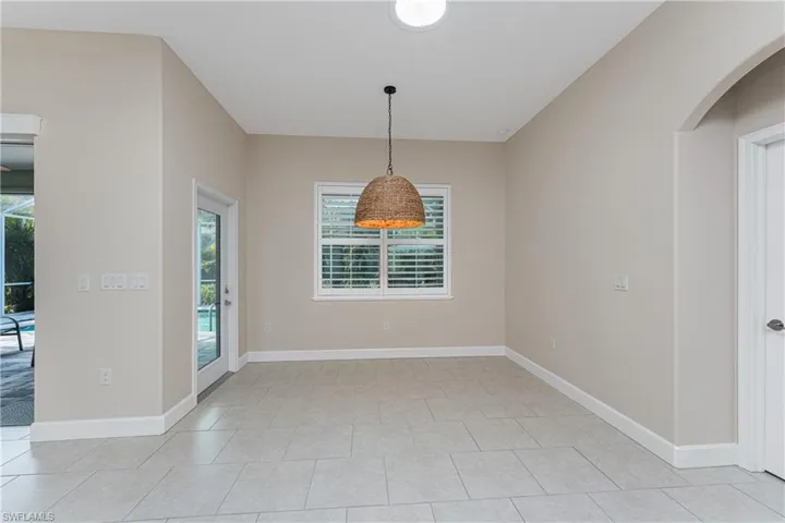 Unfurnished dining area featuring light tile patterned floors and a wealth of natural light