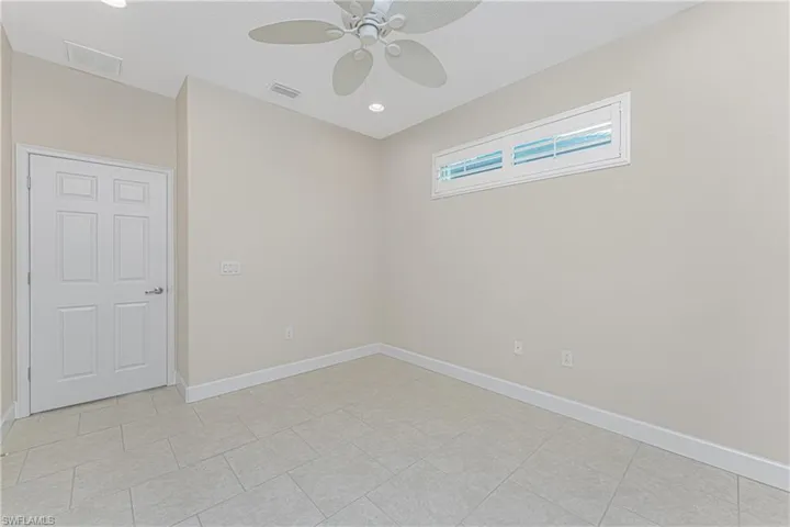 Spare room with ceiling fan