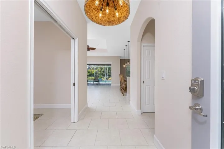 Hallway with light tile patterned floors