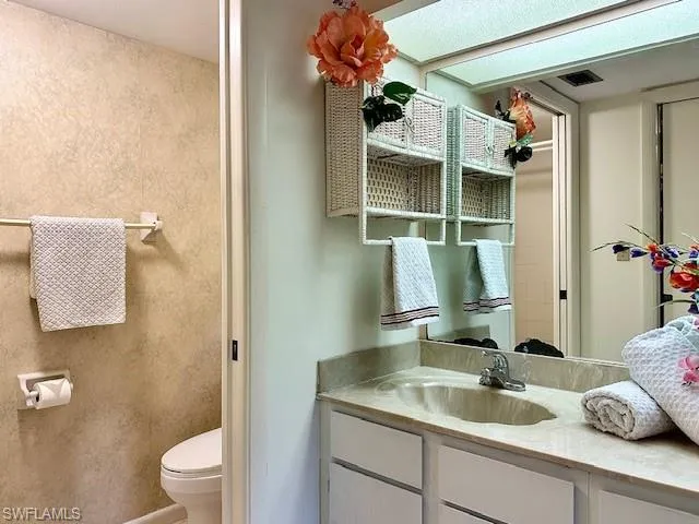 Bathroom featuring vanity and toilet