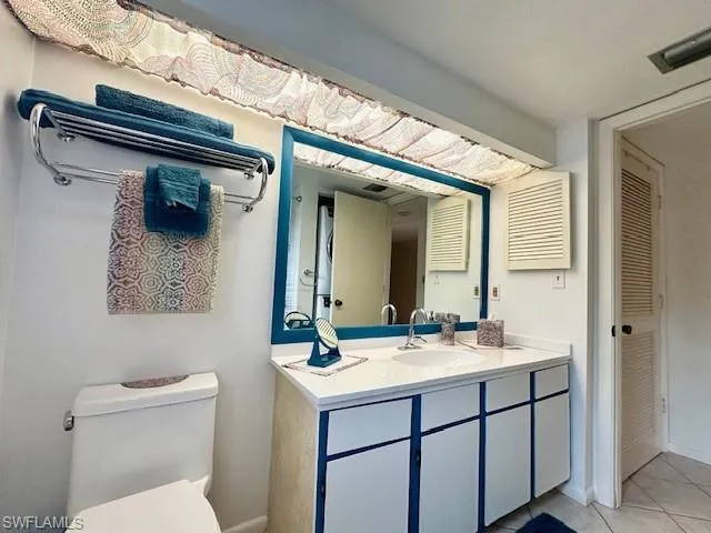 Bathroom with tile patterned floors, vanity, and toilet