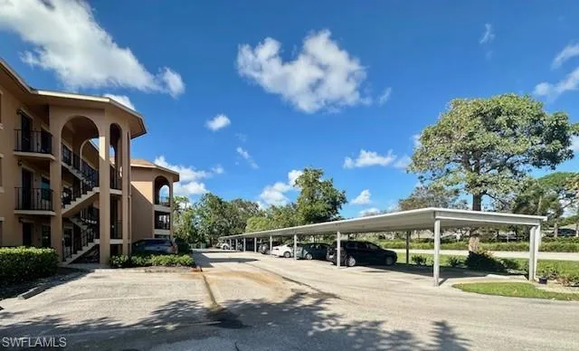 View of parking featuring a carport