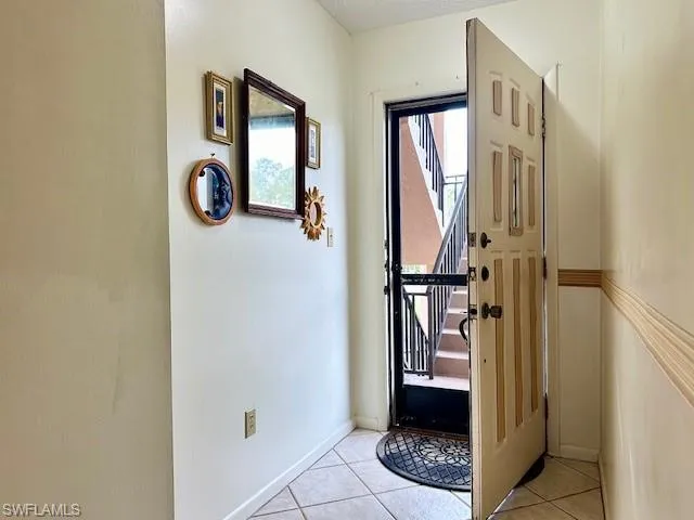 Doorway to outside featuring light tile patterned floors