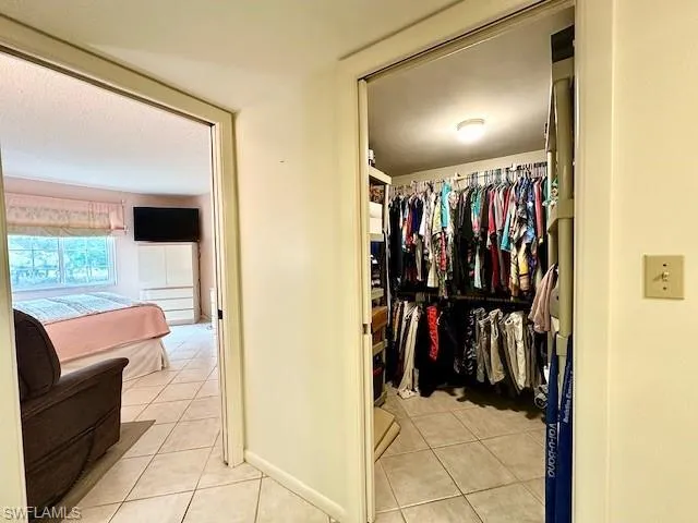 Walk in closet featuring light tile patterned flooring