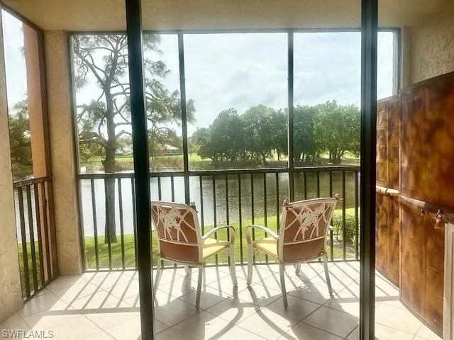 Sunroom featuring a water view and a healthy amount of sunlight
