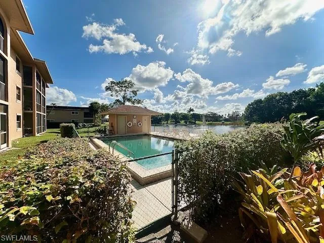 View of pool featuring a water view and a patio