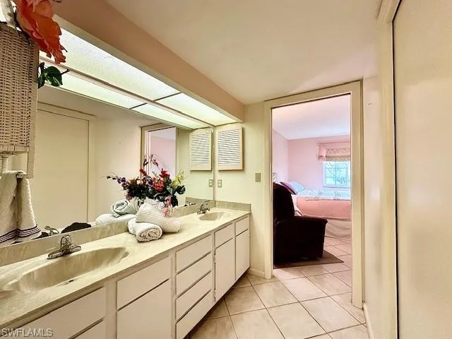 Bathroom featuring tile patterned flooring and vanity
