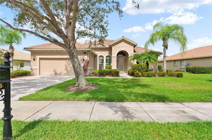 Mediterranean / spanish-style house featuring stucco siding, a front yard, concrete driveway, a tile roof, and a garage