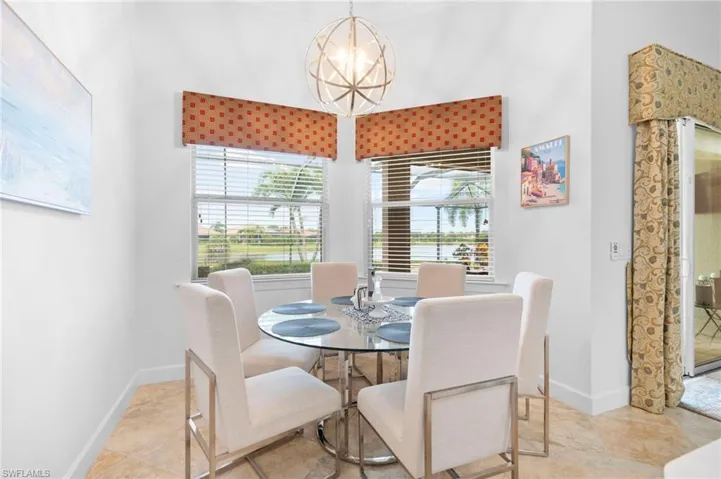 Dining room with baseboards and a chandelier