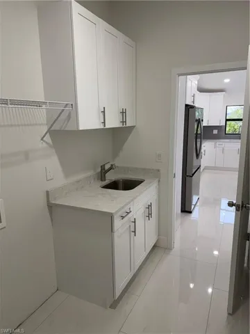 Laundry area with sink and cabinets