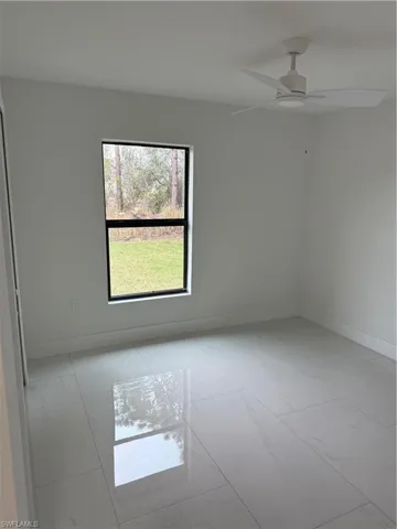 Unfurnished room featuring ceiling fan