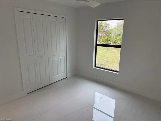 Unfurnished bedroom with a closet and multiple windows