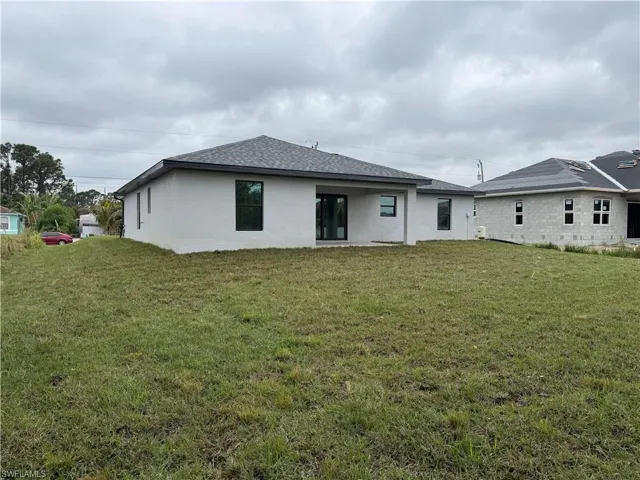 Back of house with a yard