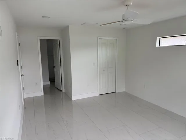 Unfurnished bedroom with ceiling fan