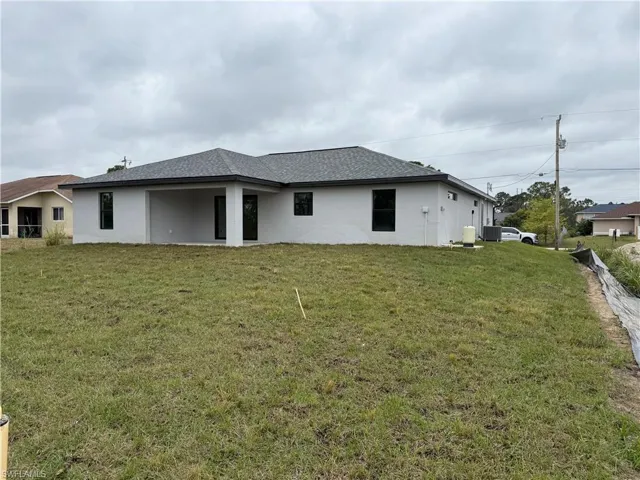 Rear view of house with a yard