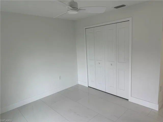 Unfurnished bedroom featuring ceiling fan and a closet