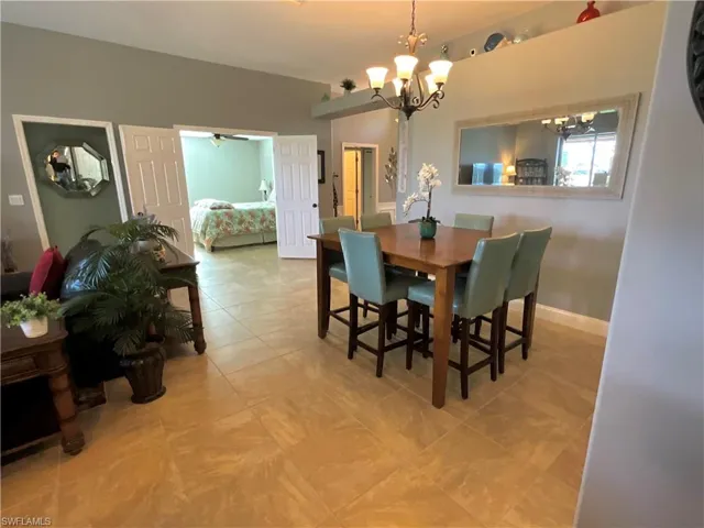 Dining area featuring ceiling fan with chandelier