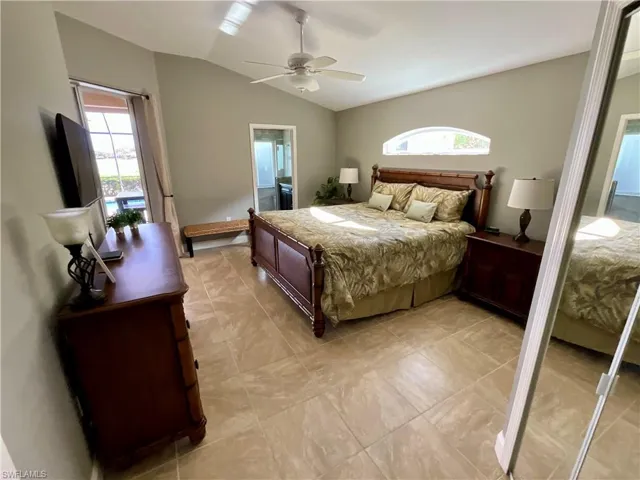 Master Bedroom with ceiling fan, ensuite bath, and vaulted ceiling