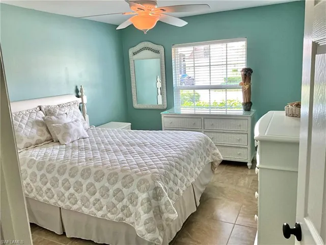 2nd Bedroom with ceiling fan and light tile patterned floors