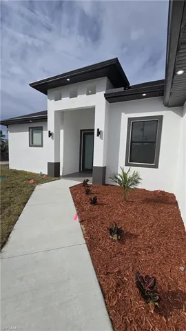 Property entrance featuring stucco siding