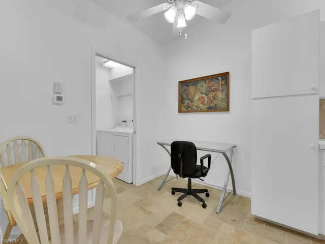 Office space featuring ceiling fan and independent washer and dryer