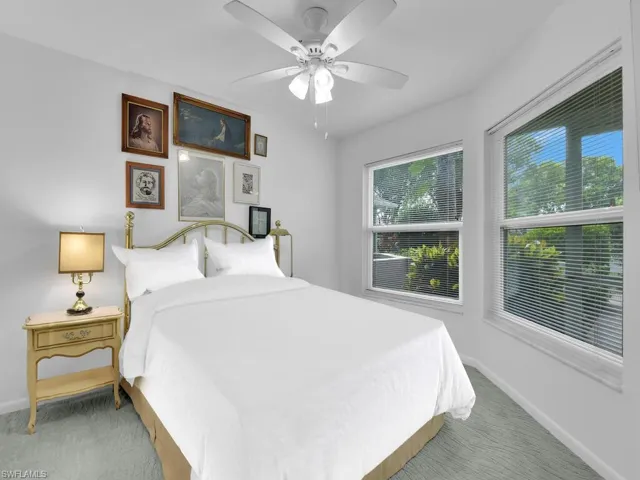 Bedroom with ceiling fan and carpet floors