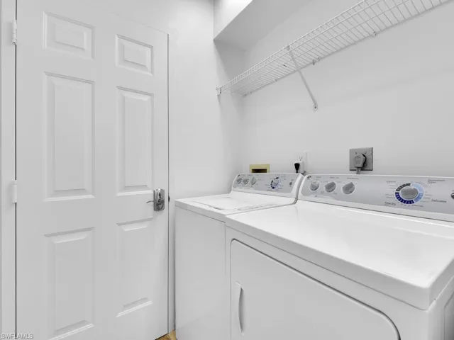 Washroom featuring washing machine and clothes dryer