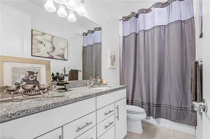 Primary bathroom featuring double sinks, lots of cabinets and spacious linen closet