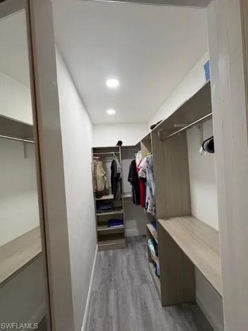 Spacious closet with light wood finished floors