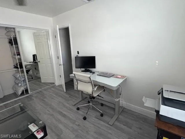 Office with wood finished floors and baseboards