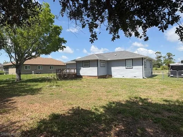 Back of house featuring a wooden deck