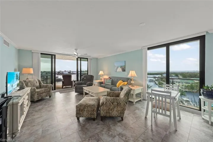 Bright open living room with 2 sets of sliding glass doors and views all around