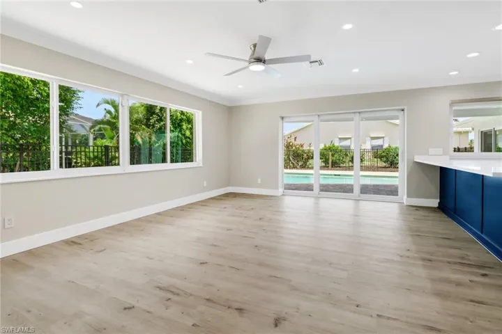 Unfurnished living room featuring light wood-type flooring, a wealth of natural light, and ceiling fan