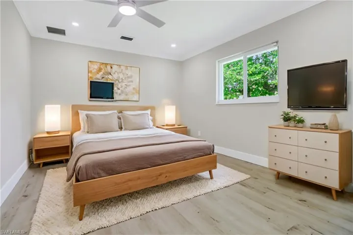 Bedroom with ceiling fan and light wood-type flooring