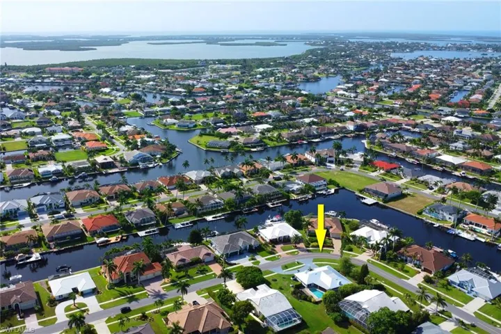 Birds eye view of property with a water view