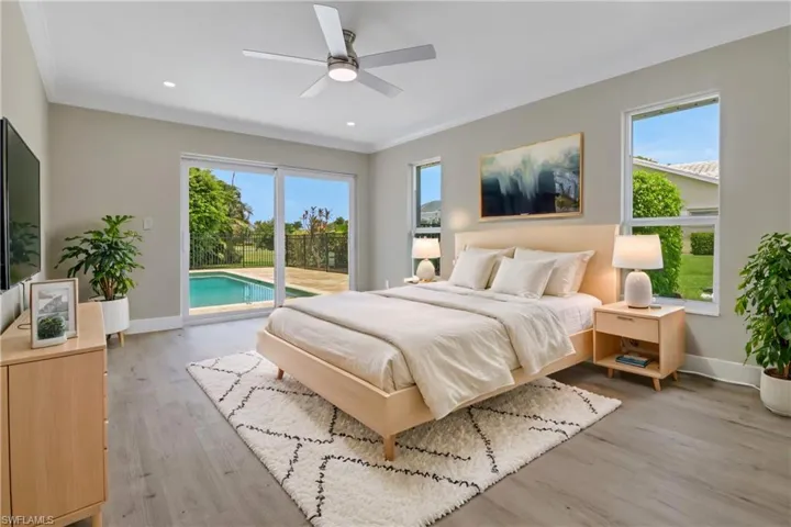 Bedroom with access to exterior, light hardwood / wood-style flooring, ceiling fan, and multiple windows