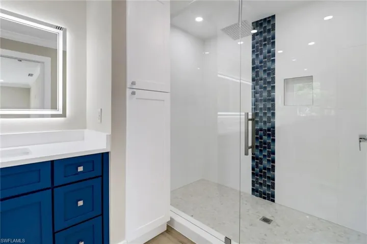 Bathroom with vanity and an enclosed shower