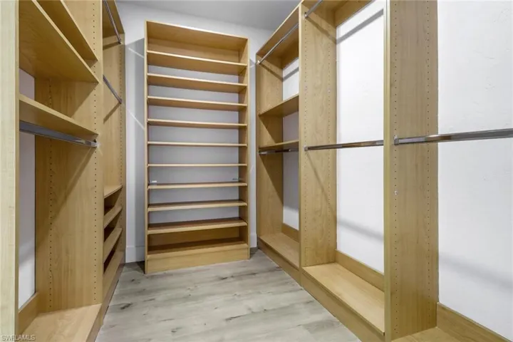 Spacious closet featuring light hardwood / wood-style floors