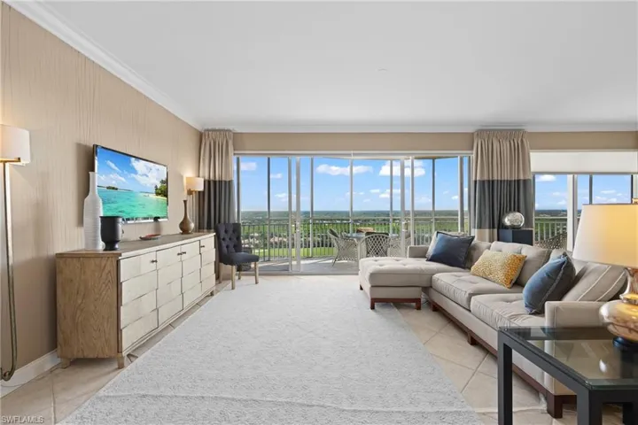Floor-to-ceiling sliding glass doors, crown molding, and tiled flooring