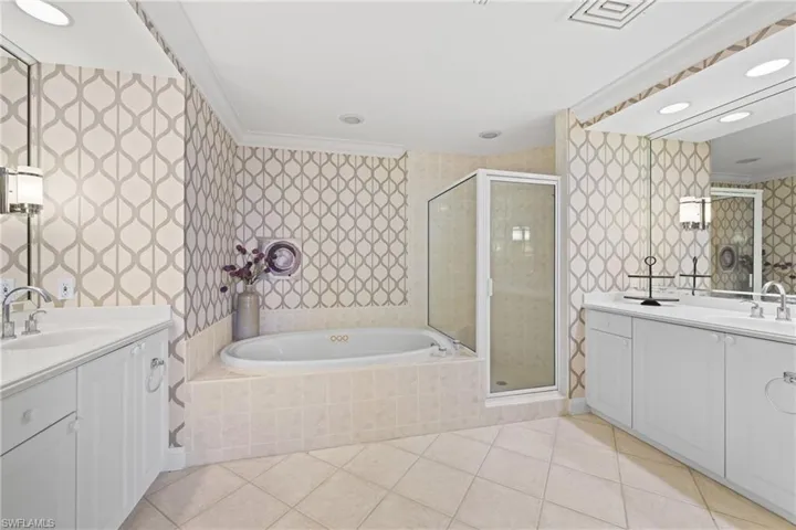 Dual vanity with white cabinetry and integrated sinks