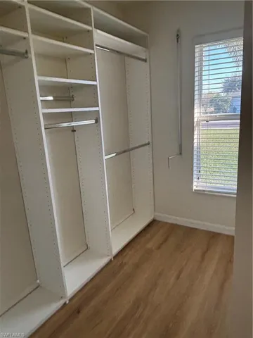 Front Primary walk-in closet with custom built in and window