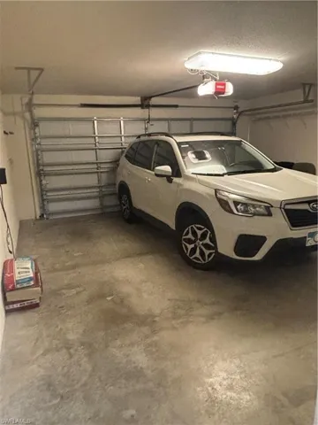 Garage featuring a garage door opener