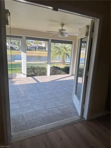 Screened Lanai featuring ceiling fan and a water view