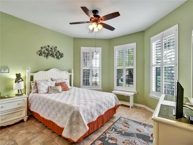 Bedroom with a ceiling fan and baseboards